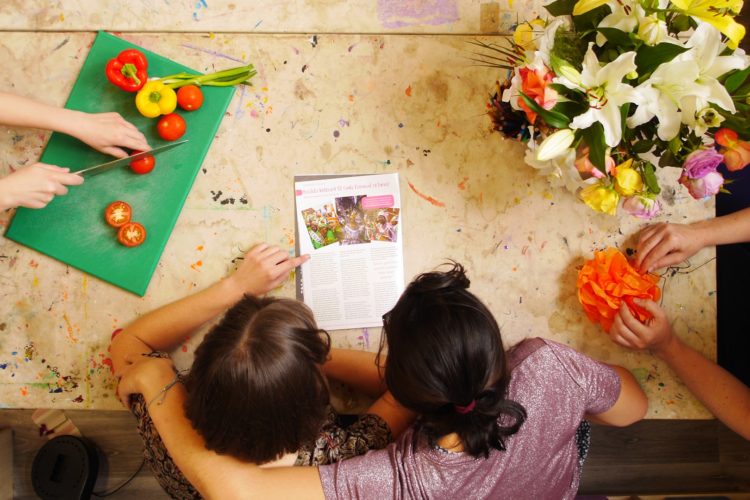 vegetables, flowers and a hug of support round a table