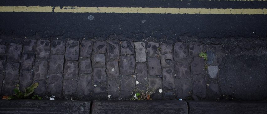 looking down on a kerb and double yellow lines